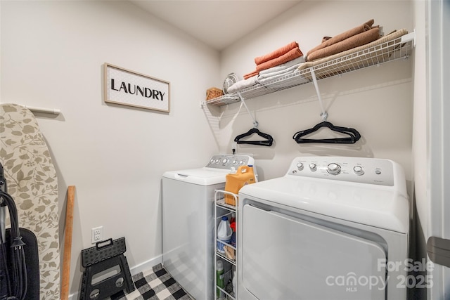 laundry area featuring washer and dryer, laundry area, and baseboards