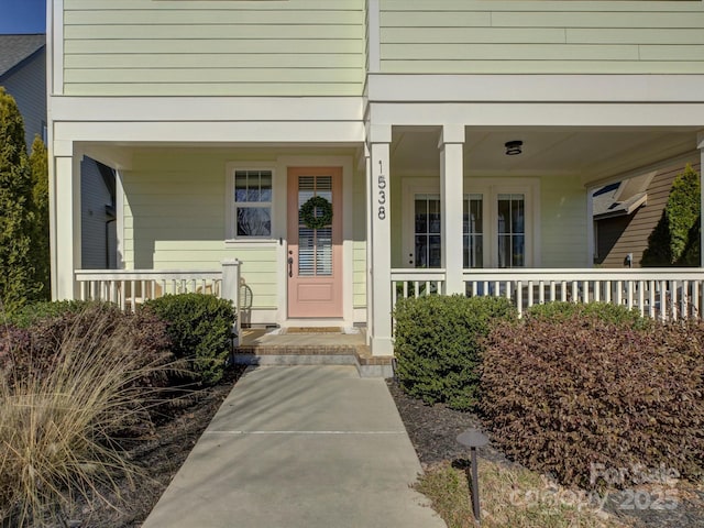 entrance to property featuring a porch