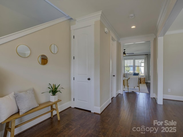 hallway featuring ornamental molding, dark wood-type flooring, recessed lighting, and baseboards