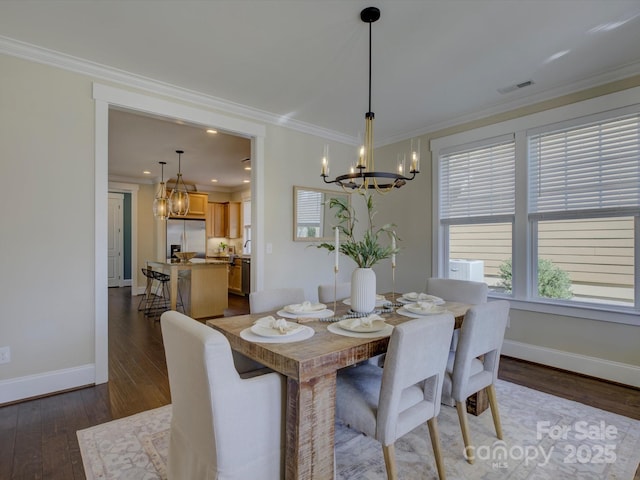 dining area featuring ornamental molding, visible vents, and a notable chandelier