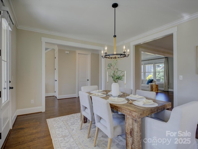 dining room featuring baseboards, dark wood-type flooring, a notable chandelier, and crown molding