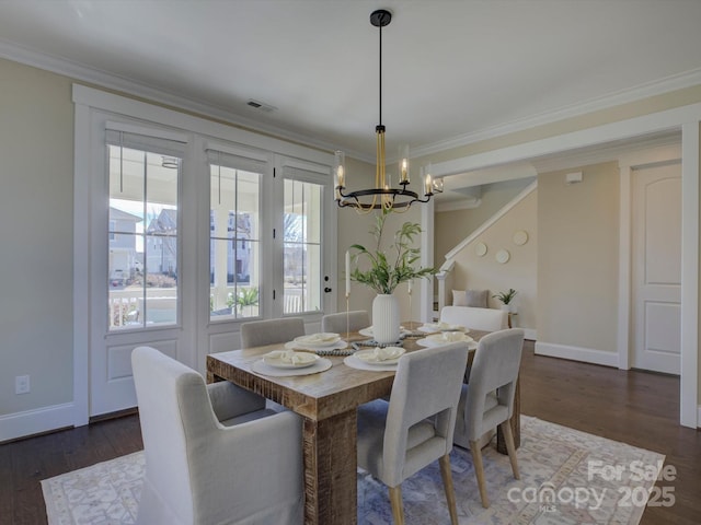 dining area with dark wood-type flooring, plenty of natural light, visible vents, and ornamental molding