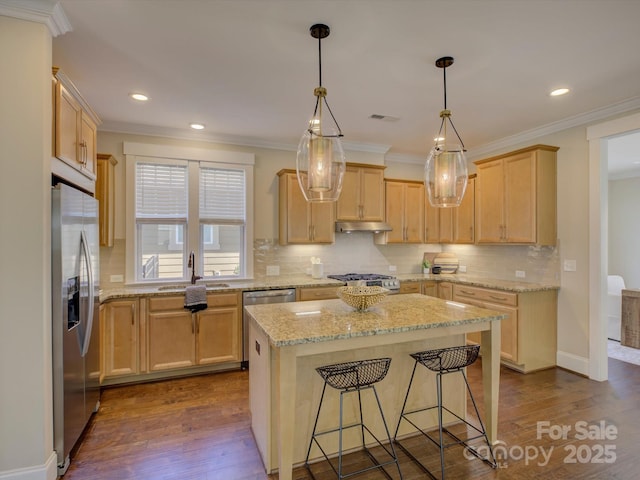 kitchen with dark wood-style flooring, stainless steel fridge, a sink, and under cabinet range hood