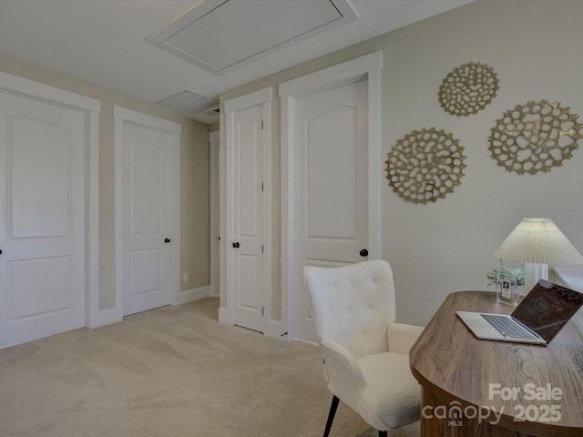 home office featuring baseboards, attic access, and light colored carpet