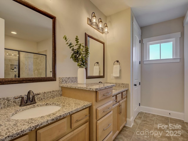 full bathroom with a shower stall, vanity, and baseboards