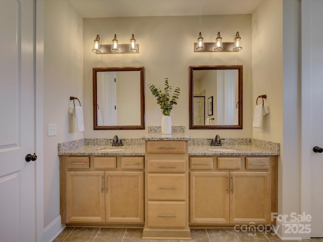 bathroom featuring double vanity, tile patterned flooring, and a sink