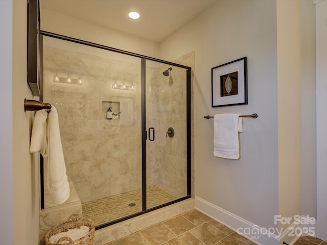 bathroom featuring a shower stall, baseboards, and recessed lighting