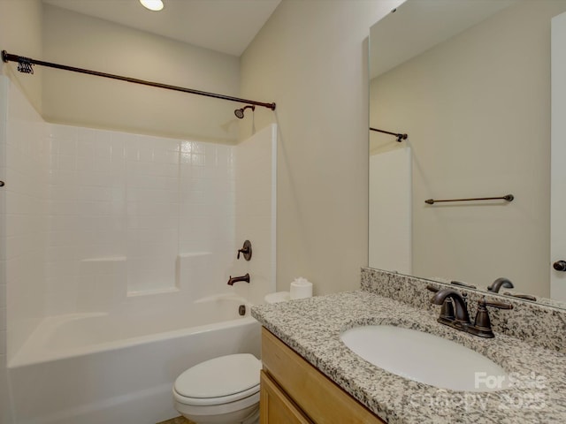 bathroom with toilet,  shower combination, and vanity