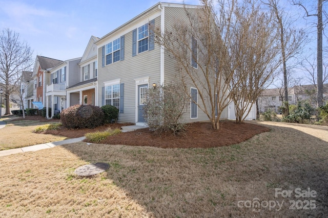 view of front of house with a garage, driveway, a front lawn, and a residential view