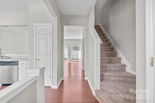 interior space featuring baseboards and wood finished floors