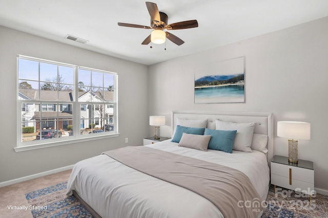 bedroom featuring carpet floors, baseboards, visible vents, and ceiling fan