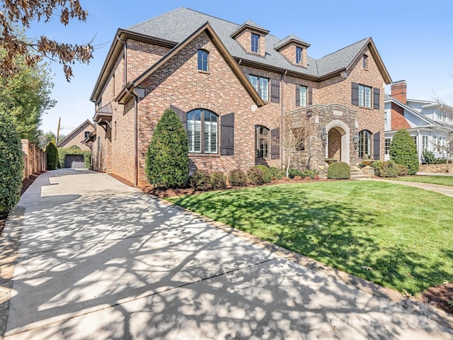 view of front of house with brick siding and a front yard