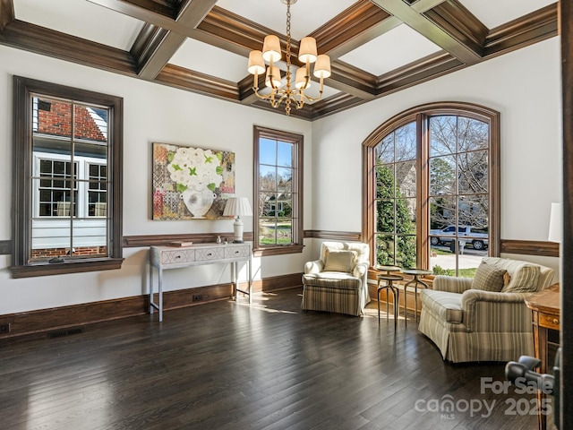 sitting room featuring coffered ceiling, wood finished floors, visible vents, beam ceiling, and an inviting chandelier