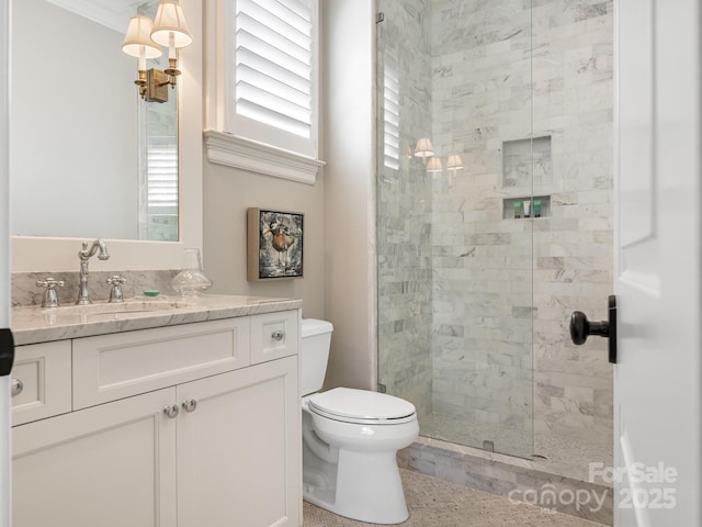 full bathroom with toilet, a shower stall, and vanity