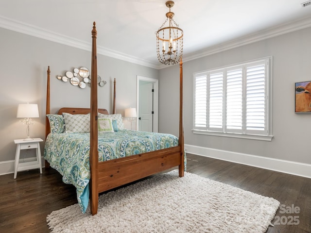 bedroom with ornamental molding, wood finished floors, and baseboards