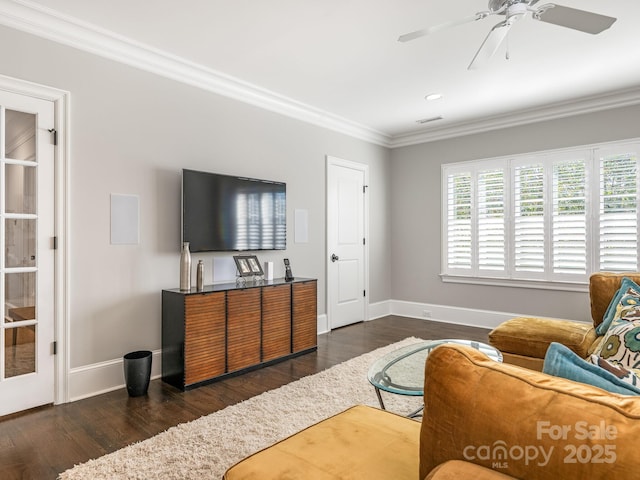 living room with visible vents, crown molding, baseboards, and wood finished floors