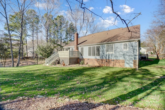 back of house featuring a deck, a yard, stairway, and a chimney