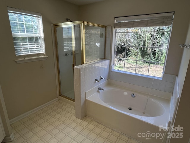 full bath with a stall shower, baseboards, a garden tub, and tile patterned floors