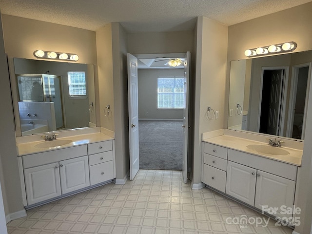 bathroom with a sink, a textured ceiling, and tile patterned floors