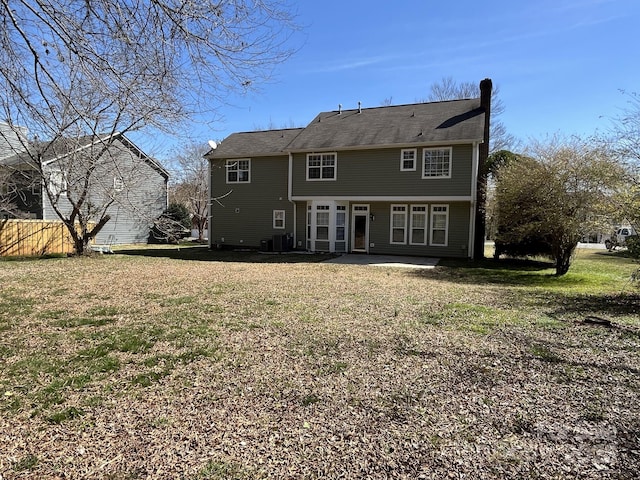 rear view of house with a yard, a patio, and cooling unit