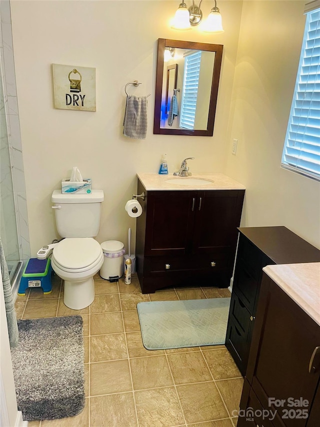 bathroom with toilet, tile patterned flooring, and vanity