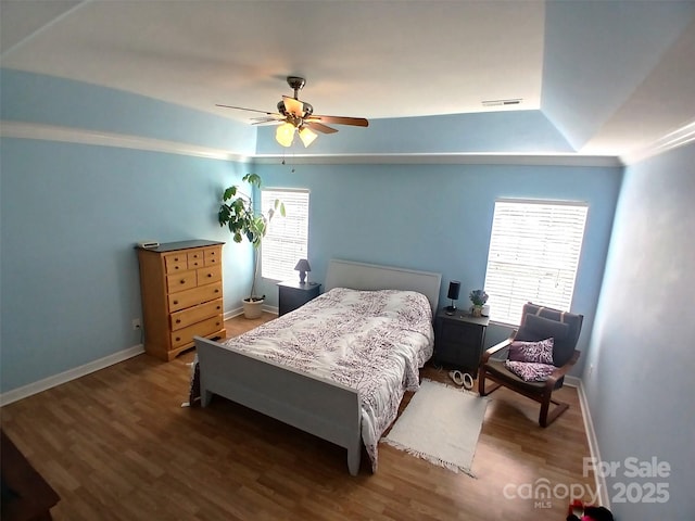 bedroom with visible vents, ceiling fan, baseboards, and wood finished floors