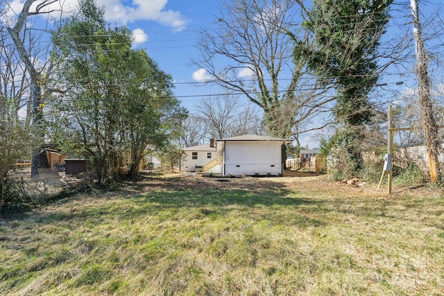 view of yard with entry steps and fence