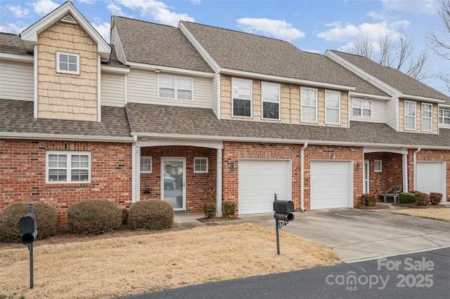 multi unit property with a shingled roof, brick siding, and driveway