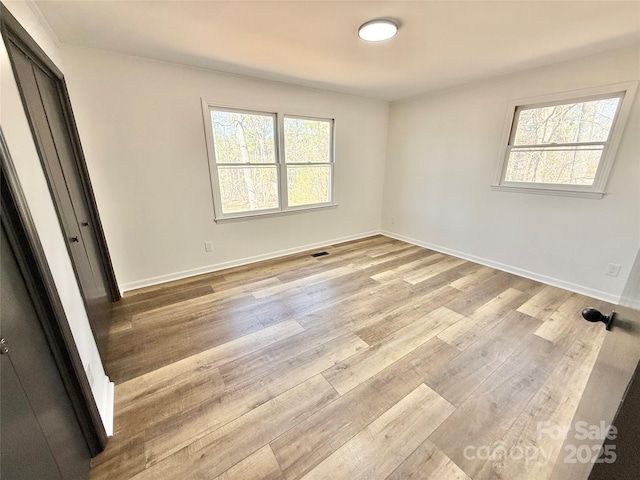 unfurnished bedroom featuring wood finished floors and baseboards