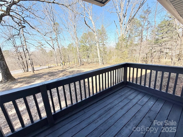 wooden terrace with a wooded view