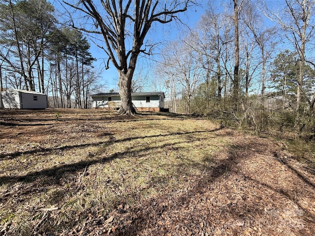 view of yard with a storage unit and an outbuilding