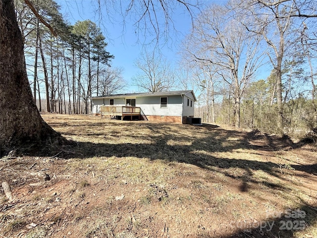 exterior space with crawl space and a wooden deck