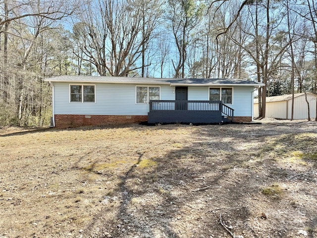 ranch-style house with crawl space, a deck, and an outbuilding