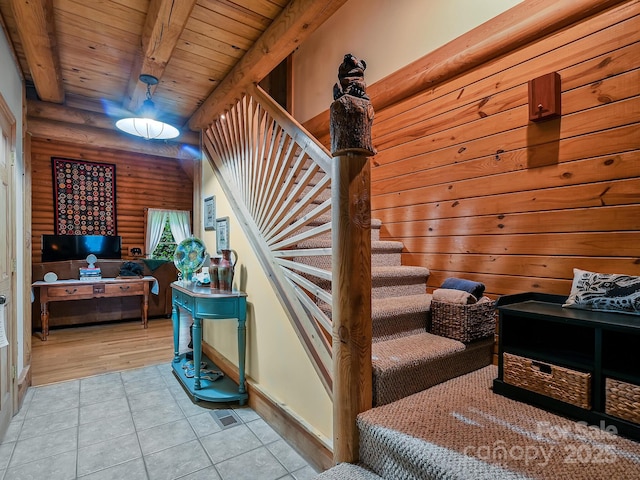 stairway with wood ceiling, beam ceiling, and tile patterned floors