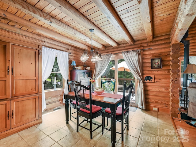 dining room with wood ceiling, a wood stove, plenty of natural light, and beam ceiling