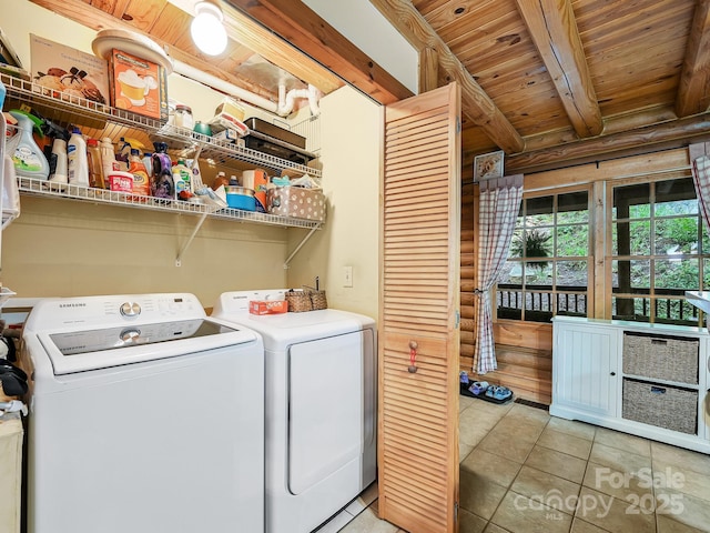 washroom featuring laundry area, light tile patterned floors, wooden ceiling, independent washer and dryer, and log walls