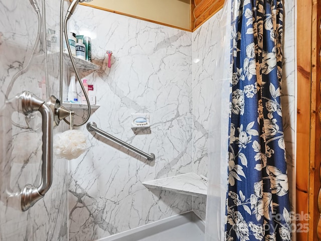 bathroom with a marble finish shower