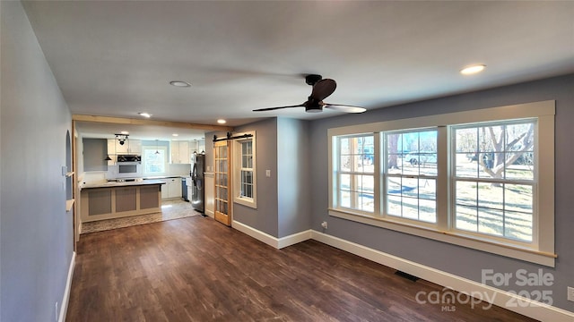 621 Watts St NE, Valdese, NC 28690 - interior space featuring recessed lighting, dark wood finished floors, a barn door, and baseboards
