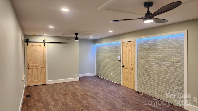621 Watts St NE, Valdese, NC 28690 - interior space with dark wood-style floors, a barn door, a ceiling fan, visible vents, and baseboards