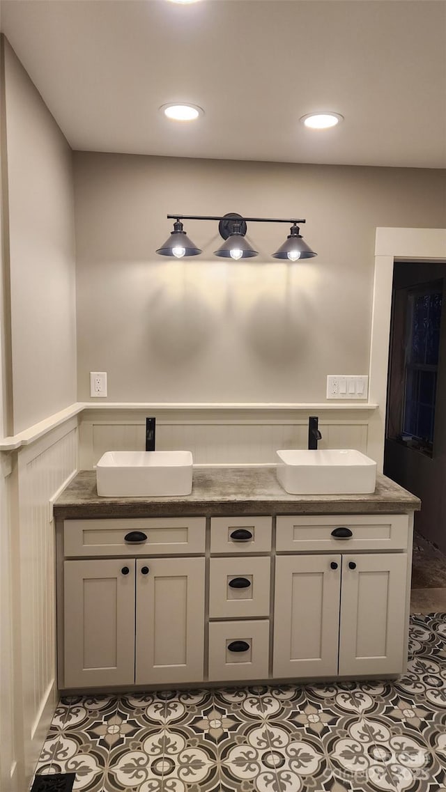 621 Watts St NE, Valdese, NC 28690 - bathroom with tile patterned flooring, a wainscoted wall, and a sink