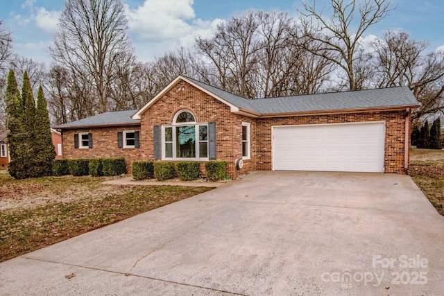 single story home featuring a garage, driveway, brick siding, and roof with shingles