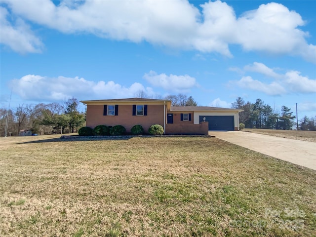 ranch-style home with concrete driveway, an attached garage, and a front lawn