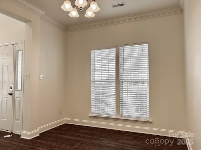 unfurnished room with dark wood-style floors, visible vents, an inviting chandelier, and ornamental molding