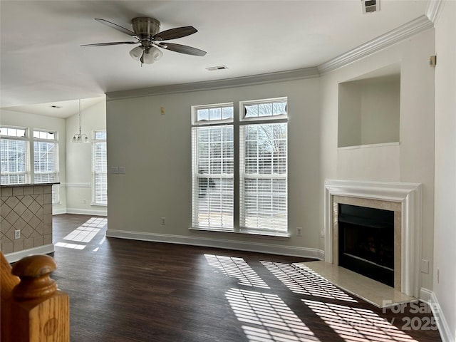 unfurnished living room with dark wood-style flooring, crown molding, baseboards, and a premium fireplace