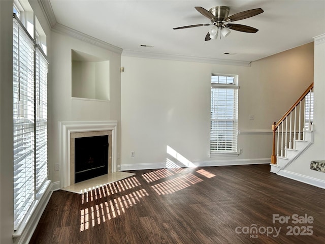 unfurnished living room with ornamental molding, stairway, a fireplace, and wood finished floors