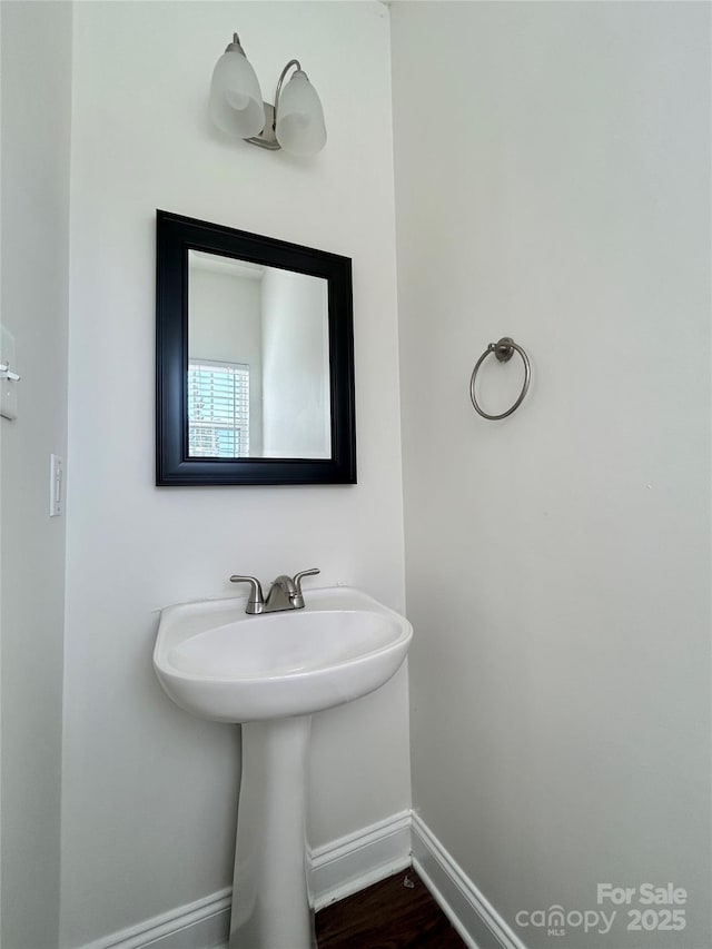 bathroom featuring baseboards and wood finished floors