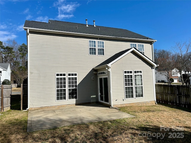 rear view of house with a patio, a lawn, and fence