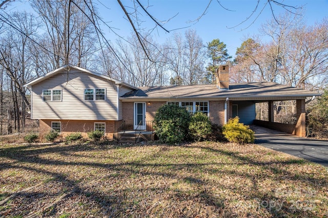 8080 Monbo Rd, Catawba, NC 28609 - tri-level home with aphalt driveway, brick siding, a chimney, a front yard, and an attached carport