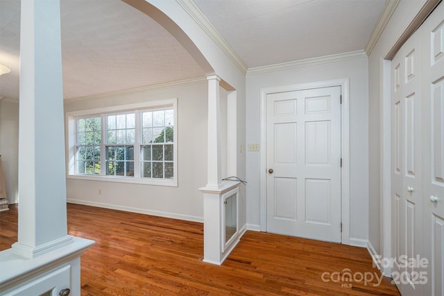 8080 Monbo Rd, Catawba, NC 28609 - entryway with arched walkways, crown molding, ornate columns, wood finished floors, and baseboards
