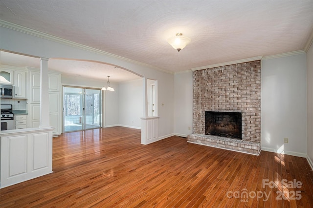 8080 Monbo Rd, Catawba, NC 28609 - unfurnished living room featuring arched walkways, light wood finished floors, a fireplace, and baseboards